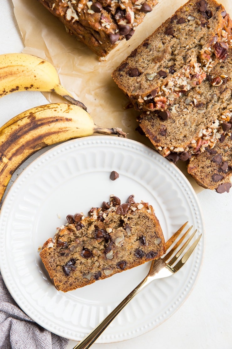 Vegan Gluten-Free Banana Bread studded with chocolate chips and pecans. A healthy, fluffy banana bread recipe that is egg-free and dairy-free!