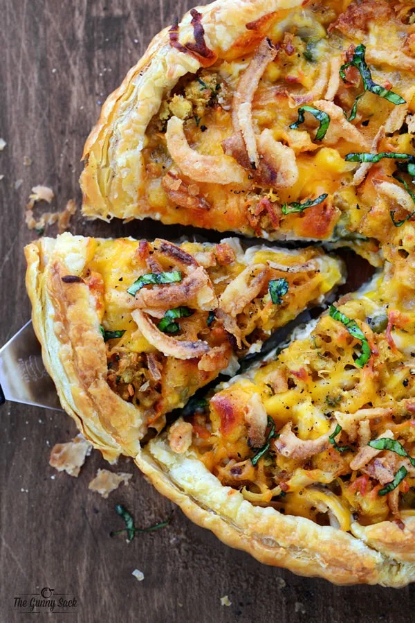 This Thanksgiving Pizza recipe is an amazing celebration of cheese and turkey. It has turkey, mashed potatoes, stuffing and more all in a puff pastry crust!
