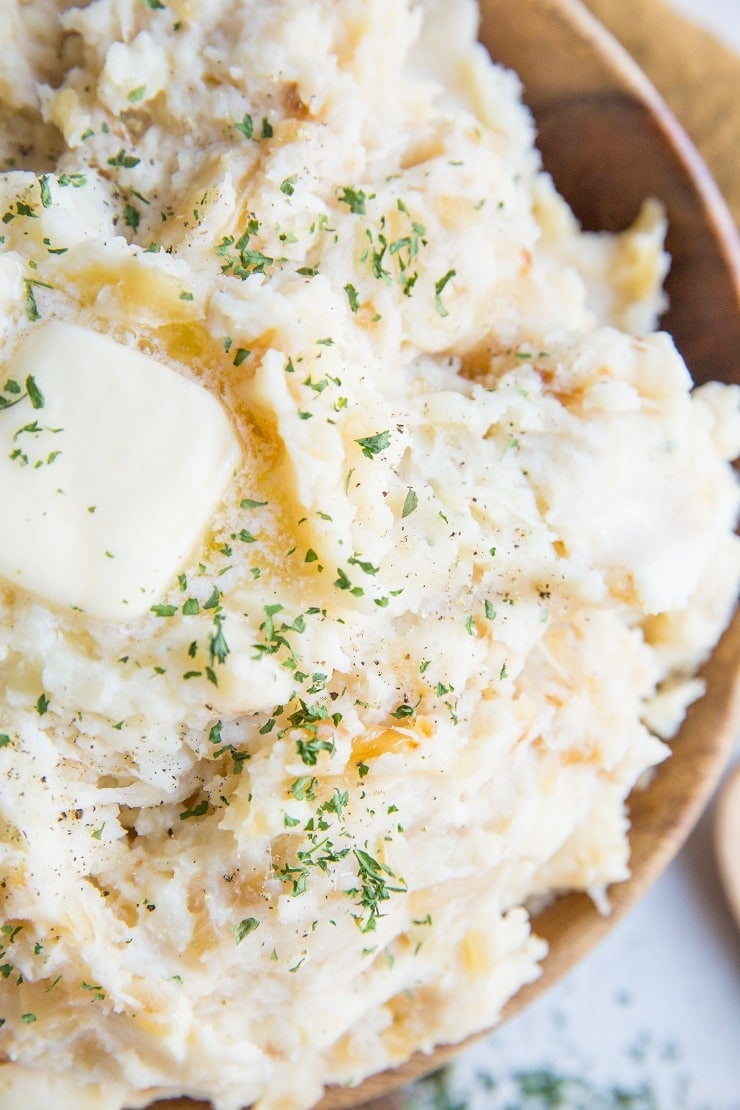 Caramelized Onion and Roasted Garlic Buttermilk Mashed Potatoes with Parmesan are just brimming with flavor! The BEST Mashed Potatoes recipe right here!