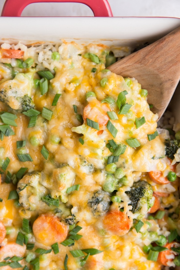 Cheesy Vegetable Brown Rice Casserole - Cheesy Vegetable and Brown Rice Casserole is here for all your side dish needs! This creamy, cheesy combination of rice and vegetables is a surefire way of getting kids to eat their veggies and is also just a marvelous delight to enjoy alongside your main dish.