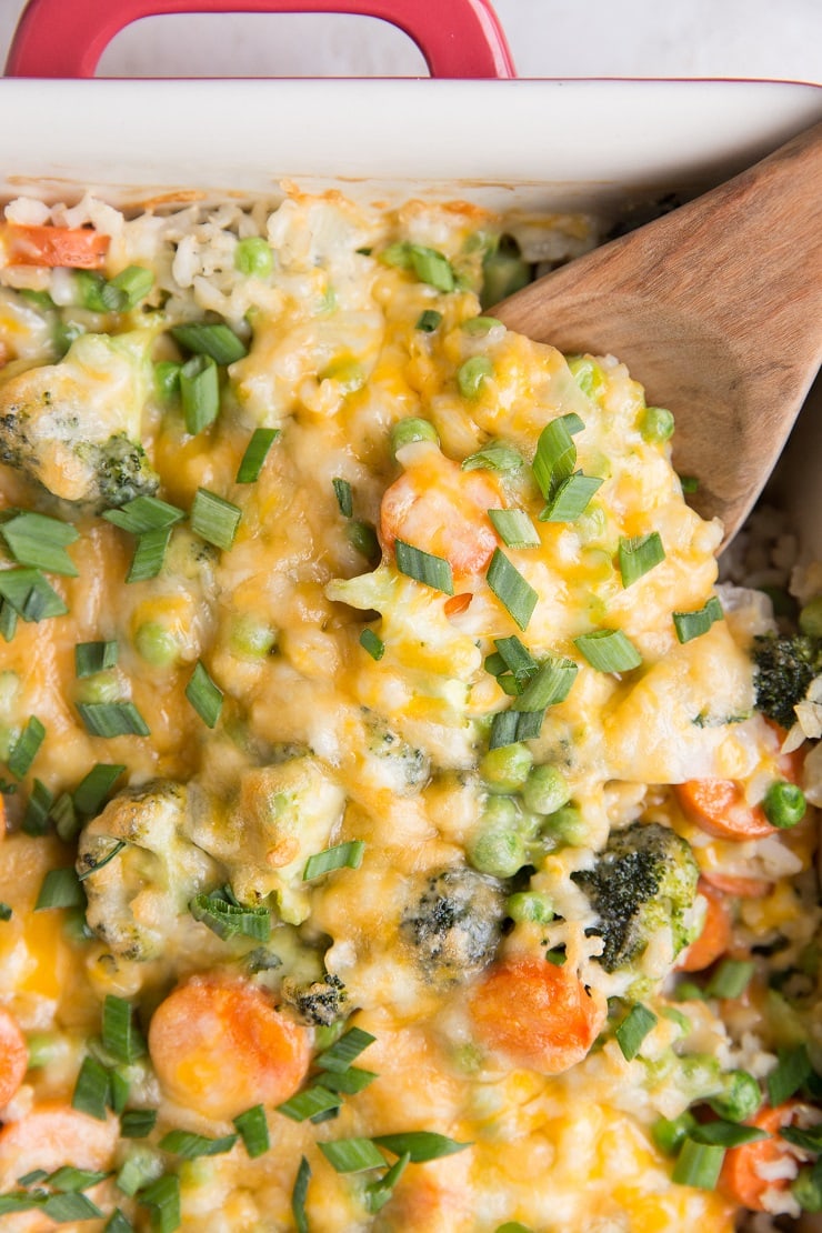 Cheesy Vegetable Brown Rice Casserole - Cheesy Vegetable and Brown Rice Casserole is here for all your side dish needs! This creamy, cheesy combination of rice and vegetables is a surefire way of getting kids to eat their veggies and is also just a marvelous delight to enjoy alongside your main dish.