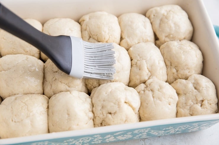 Brush the egg wash onto the balls of dough