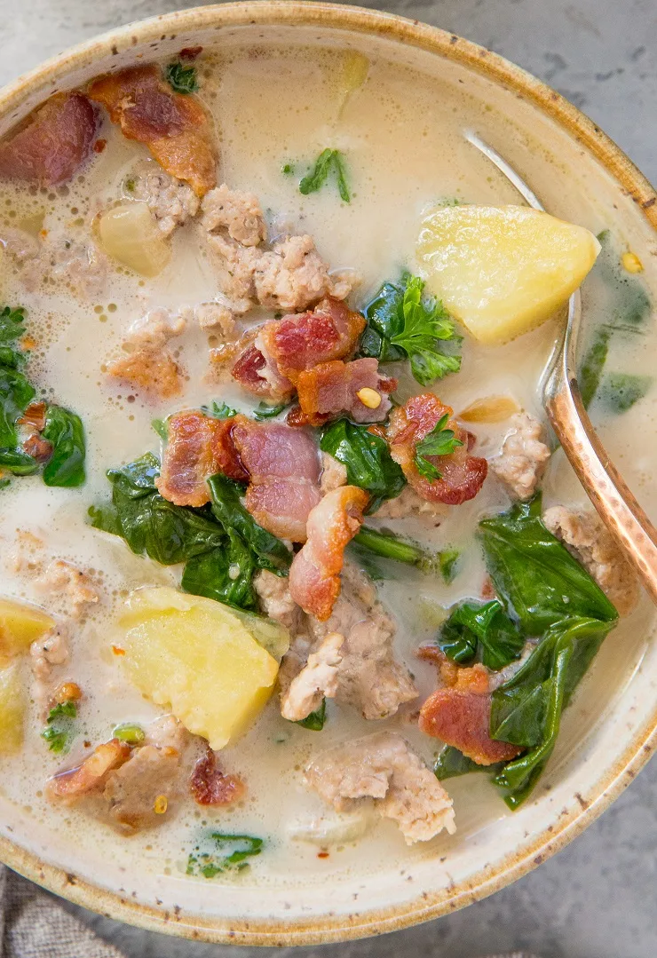 Healthy Zuppa Toscana with Italian sausage, bacon, spinach, dairy-free creamy broth and potatoes. Paleo, whole30, hearty and delicious!
