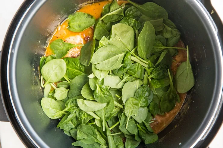 Add the spinach and put the lid back on until the spinach has wilted.