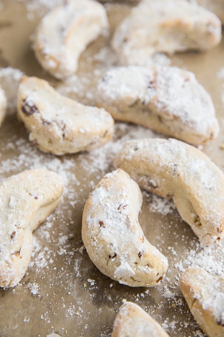 Paleo Mexican Wedding Cookies are egg-free, grain-free, refined sugar-free and can easily be made vegan. These festive cookies are marvelous additions to any holiday gathering or cookie exchange.