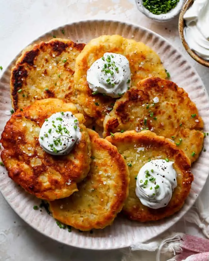 These potato pancakes are delicious and easy to make with or without leftover mashed potatoes! It only takes 8 ingredients to make the best potato pancakes! 