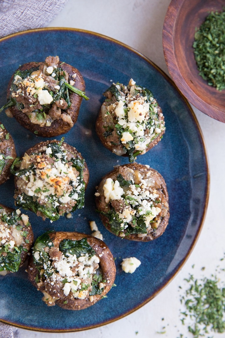 Ground Beef & Feta Stuffed Mushrooms with caramelized onion, garlic, and spinach makes for the perfect bite! This simple yet powerfully flavorful appetizer recipe is a winner for any gathering!