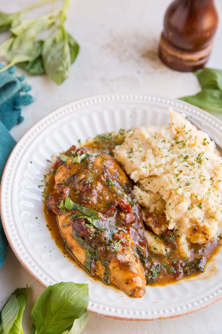 Baked Sun-Dried Tomato Chicken with a creamy garlic basil sauce. Dairy-free, gluten-free, rustic and delicious!