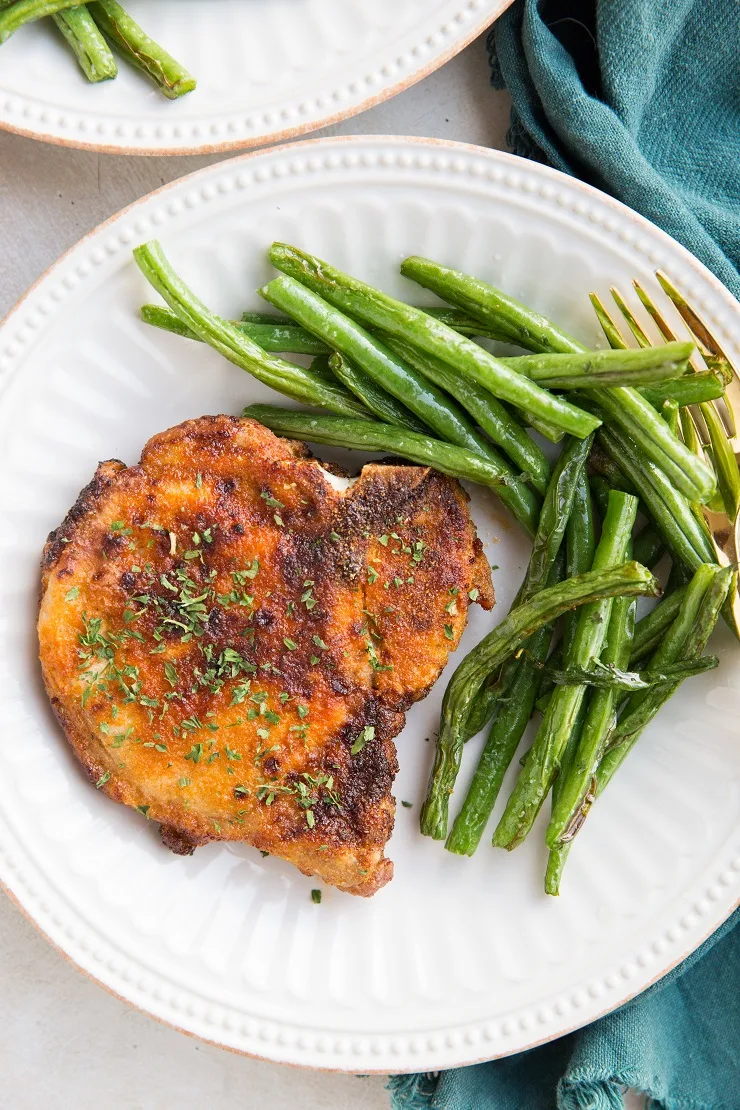 Perfectly tender and delicious Pork Chops in the Air Fryer with Green Beans - an easy dinner recipe perfect for any night of the week.
