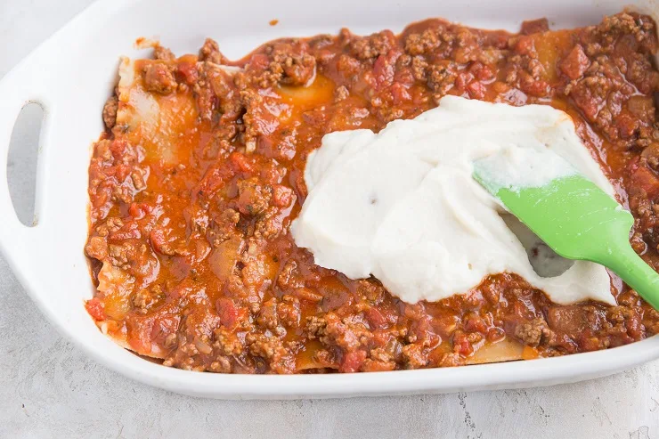 Spread one third of the meat sauce over the lasagna followed by the cauliflower sauce