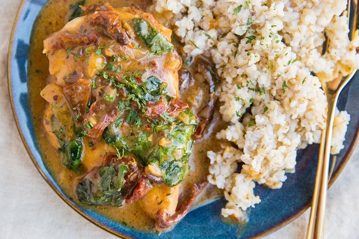 Instant Pot Tuscan Chicken with spinach and sun-dried tomatoes and a creamy dairy-free sauce. A healthier dinner recipe for any night of the week.