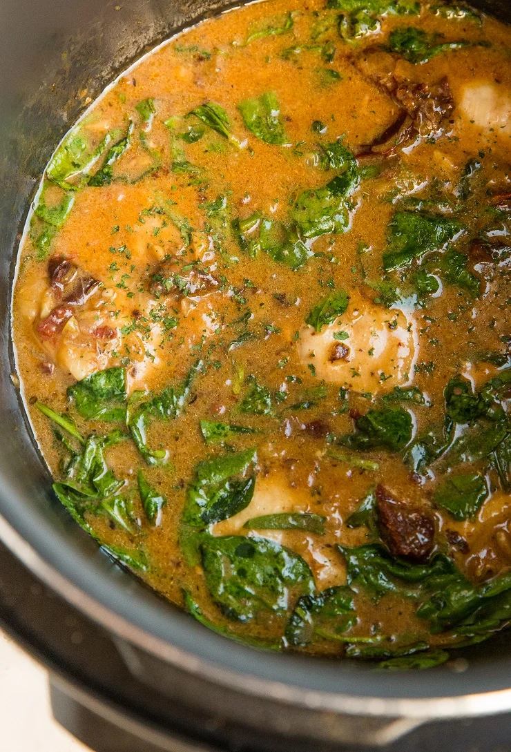Instant Pot Tuscan Chicken with a creamy sun-dried tomato sauce. Dairy-free, healthy dinner recipe