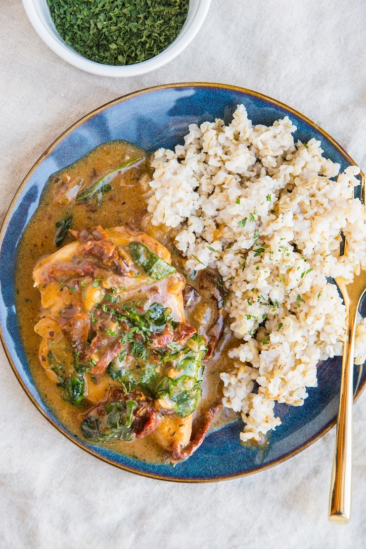 Creamy Instant Pot Tuscan Chicken with a dairy-free sun-dried tomato sauce. Easy, healthy, delicious dinner recipe.