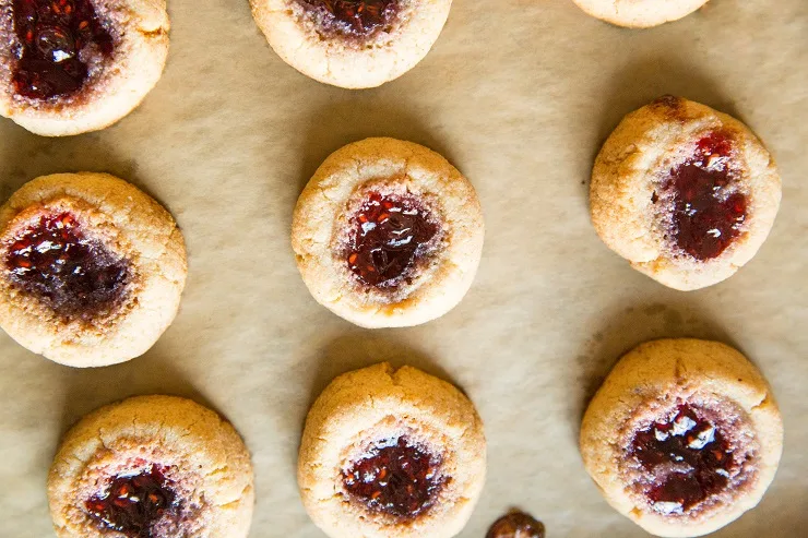 Bake the thumbprint cookies until golden-brown around the edges
