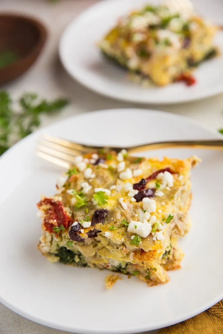 Greek Breakfast Casserole with sausage, sun-dried tomatoes, kalamata olives, feta cheese, spinach, and artichoke hearts. A wildly flavorful low-carb breakfast!