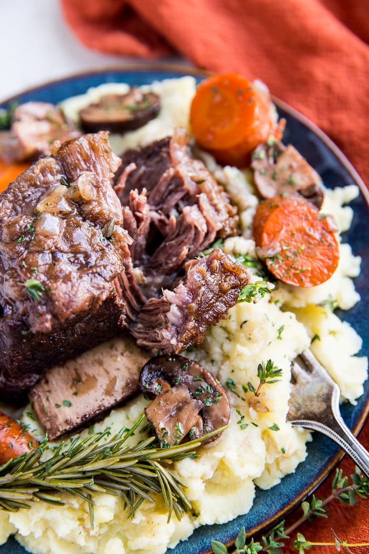 Tender, amazing Slow Cooker Short Ribs with mushrooms, carrots, and delicious gravy. Everything you need to know about making perfect short ribs