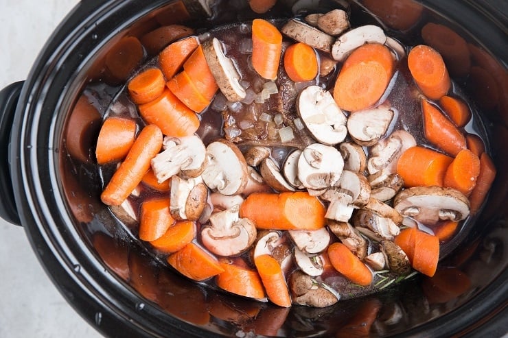 Add the veggies to the slow cooker and slow cook
