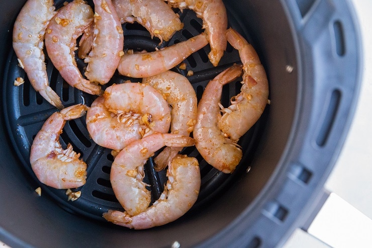Put the raw shrimp in the air fryer in a single layer