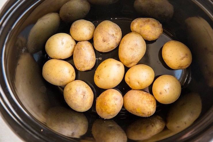 Add the potatoes to the bottom of the crock pot