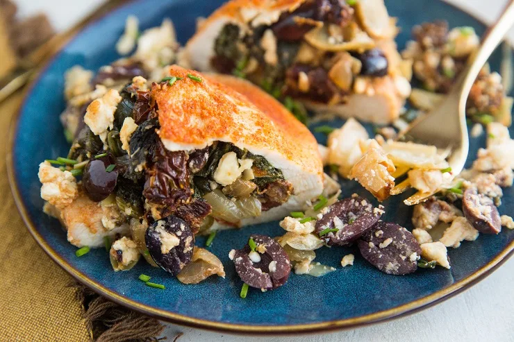 Mediterranean Stuffed Chicken with sun-dried tomatoes, artichoke hearts, feta, olives, spinach, and onion. A healthy, flavorful weeknight dinner recipe