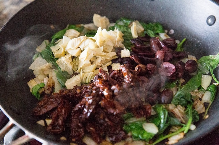 Add the kalamata olives, sun-dried tomatoes, artichoke hearts and spinach and stir well until spinach has wilted.