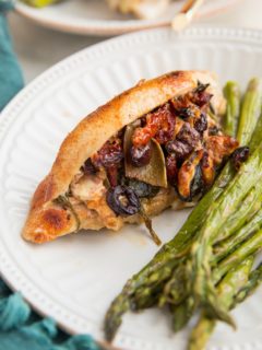 Mediterranean Stuffed Chicken with feta cheese, sun-dried tomatoes, kalamata olives, artichoke hearts, onion, and spinach. An easy, flavorful low-carb dinner recipe!