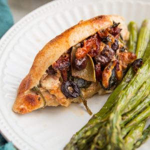 Mediterranean Stuffed Chicken with feta cheese, sun-dried tomatoes, kalamata olives, artichoke hearts, onion, and spinach. An easy, flavorful low-carb dinner recipe!