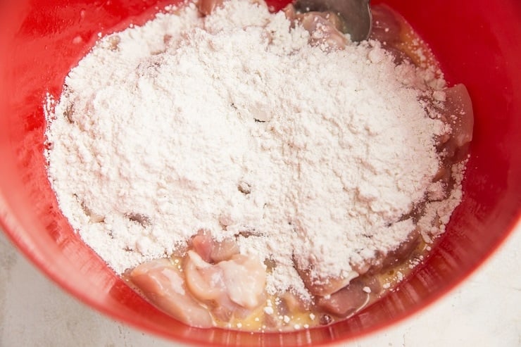 Coat the chicken in beaten egg, then add the flour