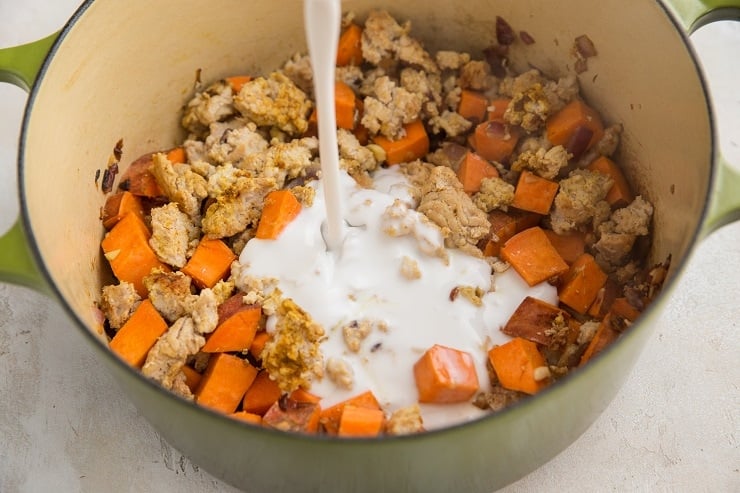 Pour the coconut milk and chicken broth in.