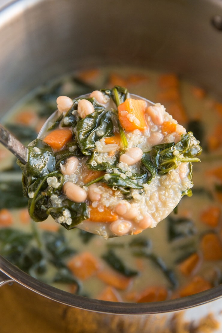 Vegan Sweet Potato Quinoa Stew with white beans and spinach. An easy dairy-free gluten-free soup recipe that is loaded with nutrients.