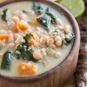 Creamy Vegan Sweet Potato and Quinoa Stew with white beans and spinach. An easy, filling meatless soup recipe