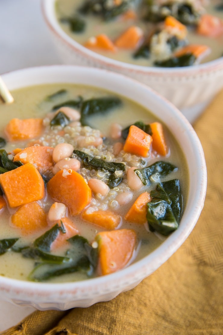 Vegan Sweet Potato and Quinoa Stew with creamy coconut milk broth, spinach, white beans, and onion. A flavorful, healthy soup recipe