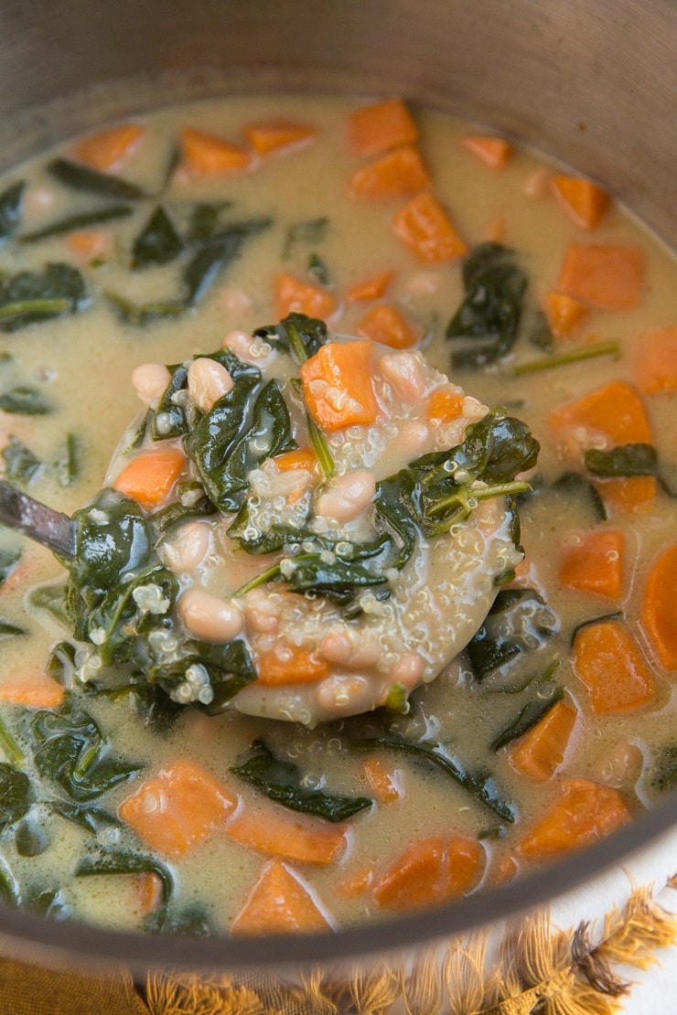 Creamy Vegan Sweet Potato and Quinoa Stew with white beans and spinach. A healthy vegetarian gluten-free soup recipe.