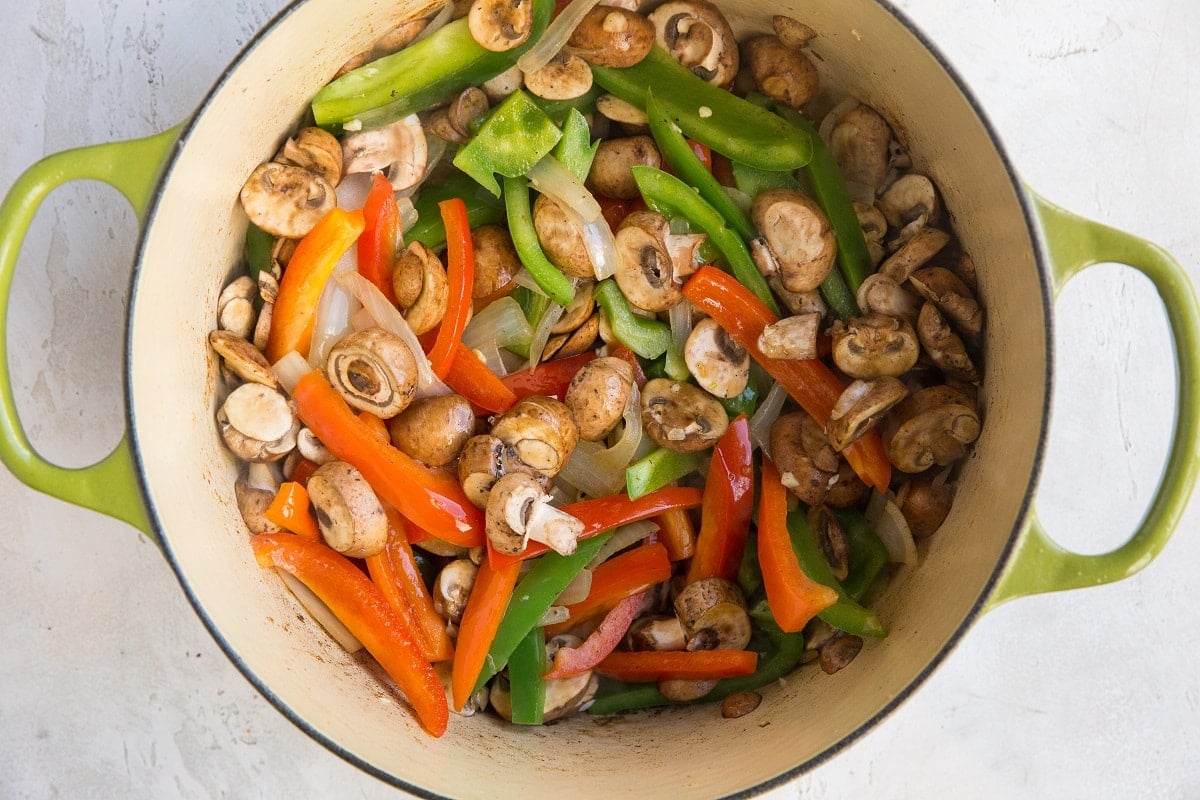 Onion, bell pepper and mushrooms in a Dutch oven