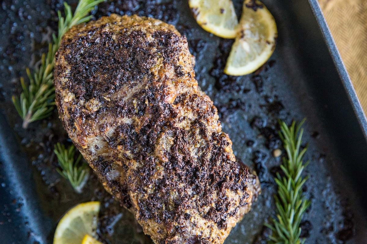 Finished beef sitting in a roasting pan after baking