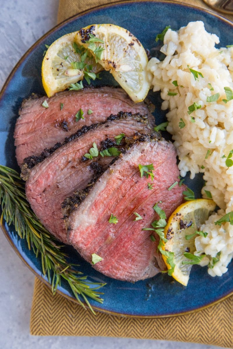 Slices of beef on a plate with risotto