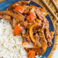 Blue plate of healthy Beijing Beef with a side of cauliflower rice