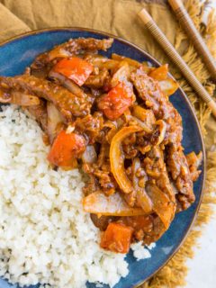 Blue plate of healthy Beijing Beef with a side of cauliflower rice