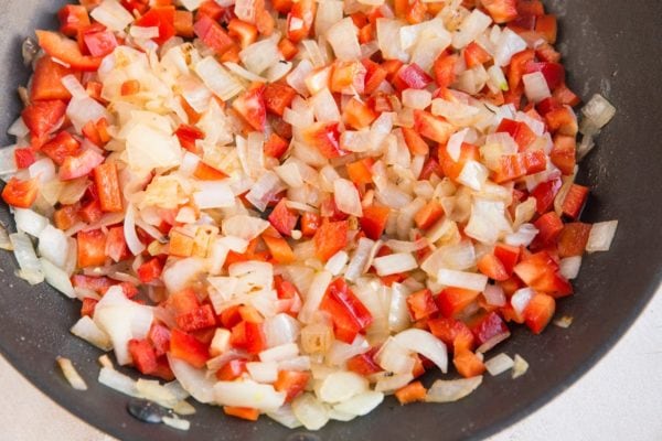 Onion, garlic and bell pepper in a skillet sautéing