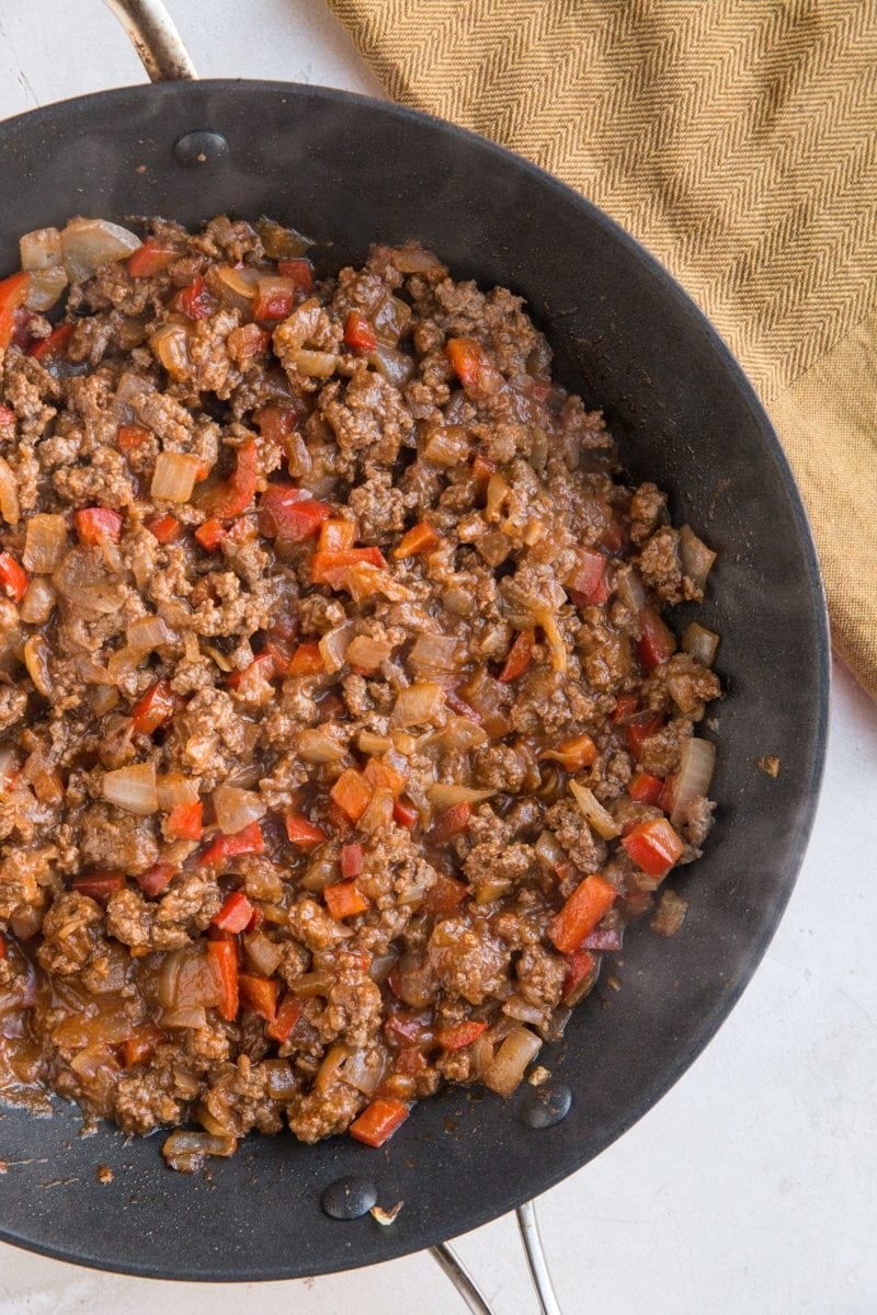 Sloppy Joe meat mixture in a skillet with a napkin next to it