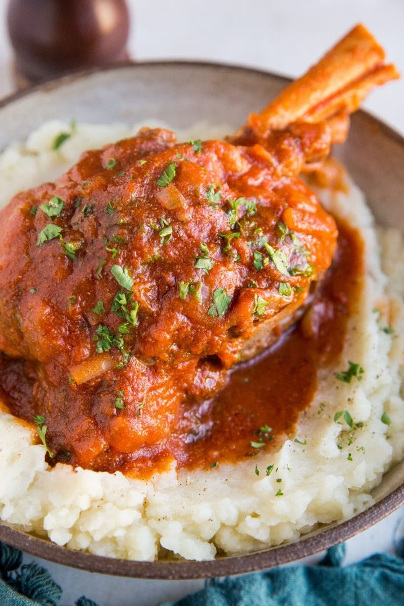 Instant Pot Lamb Shanks in a rich, delicious sauce served over mashed potatoes makes for a romantic dinner