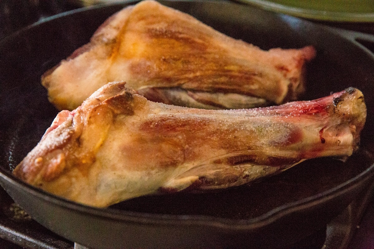 Sear the lamb shanks in a cast iron skillet