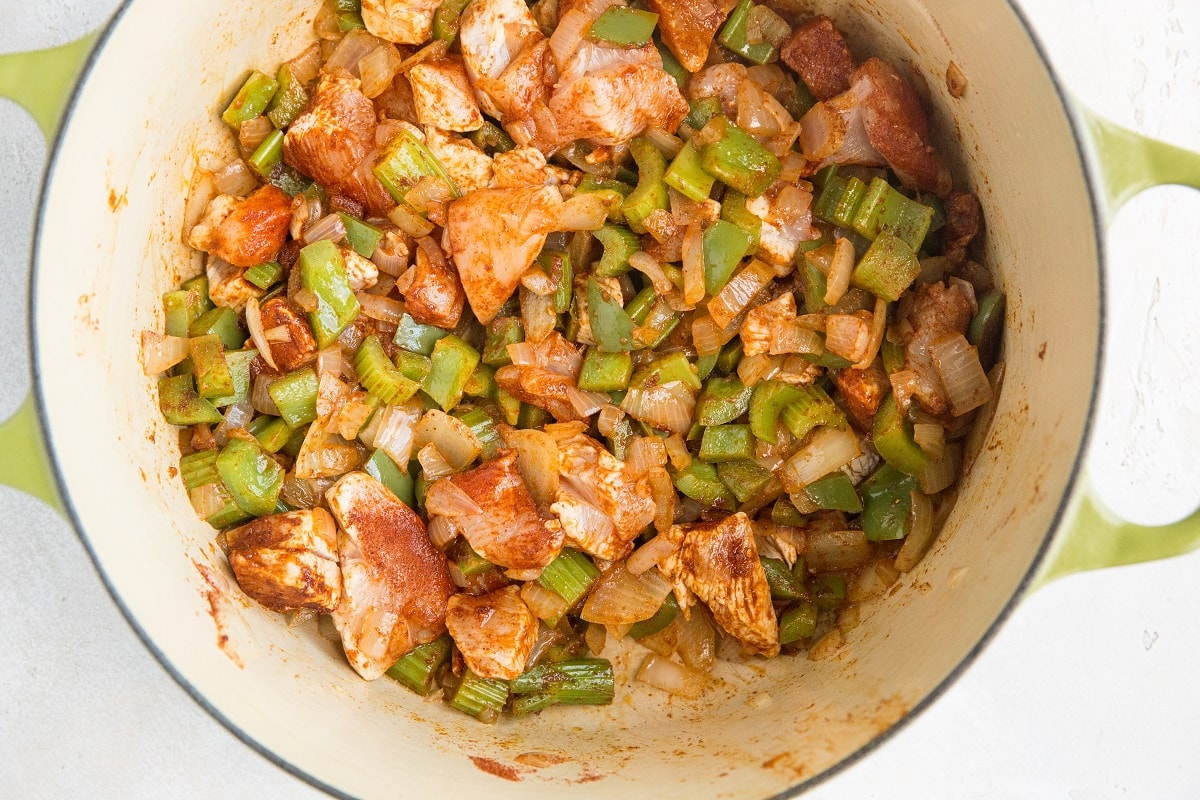 Jambalaya ingredients cooking in a Dutch oven
