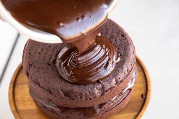 Ganache being poured over the brownie cake