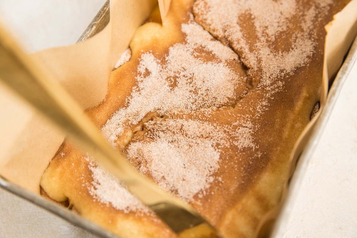 Butter knife making a large S shape in the bread batter to create swirl