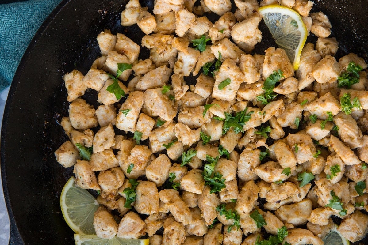 Lemon Garlic Chicken bites in a cast iron skillet