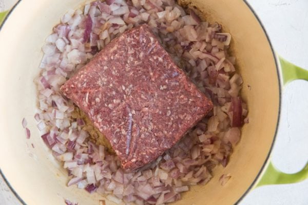 Brown the meat in the pot before chopping it into smaller pieces and mixing it in