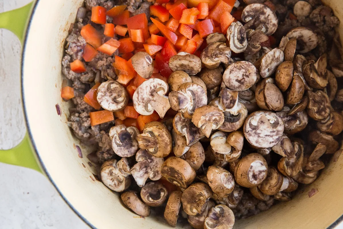 Stir in the mushrooms, seasonings, and bell pepper