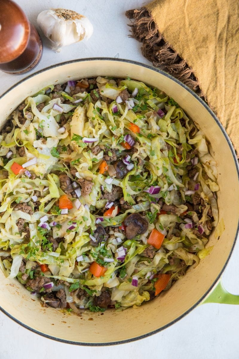 Easy One-Pot Ground Beef and Cabbage with onion, garlic, bell pepper, and mushrooms. An easy healthy low-carb dinner recipe that comes together in 30 minutes.