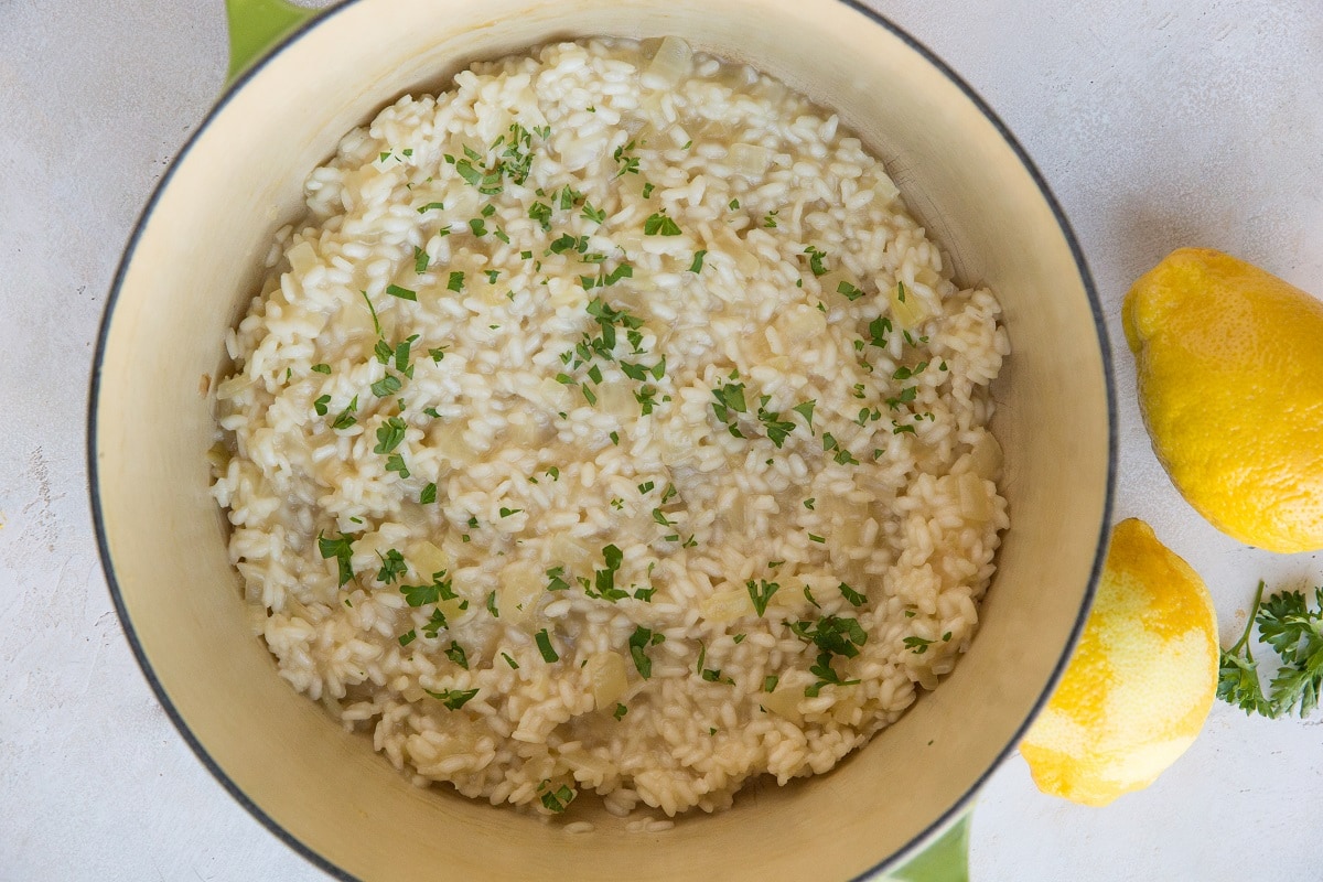 Continue cooking the risotto, adding chicken broth once liquid has been absorbed